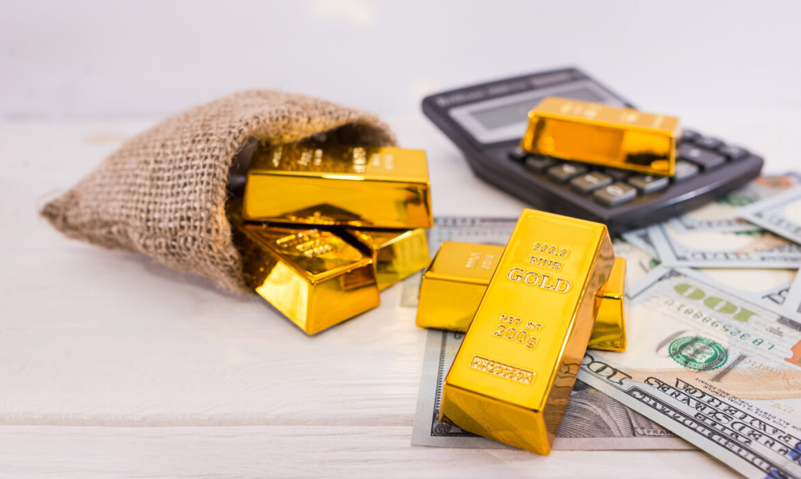 gold bars and calculator with dollars.